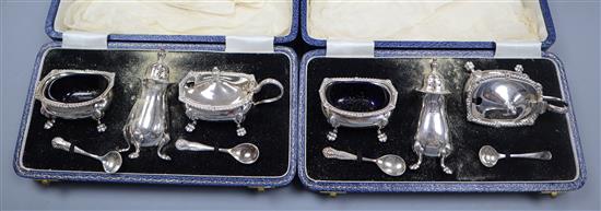 Two cased silver three piece cruet sets.